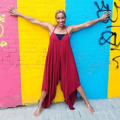 owner judy stewart posing with colorful wall