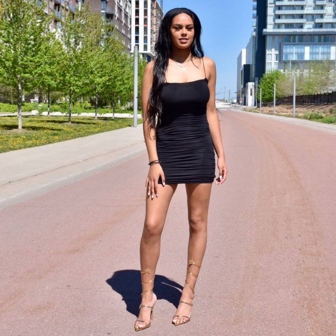 Tall black  young female wearing gold strappy wide with shoes for big feet