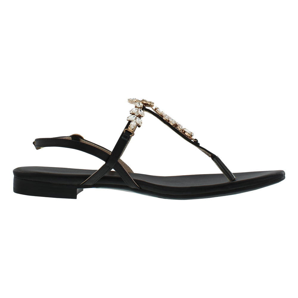 
                  
                    Load image into Gallery viewer, A side shot of a beautiful black women&amp;#39;s thong style sandal with a flat heel, sling back with buckle, and clear gemstones held with gold casing.
                  
                